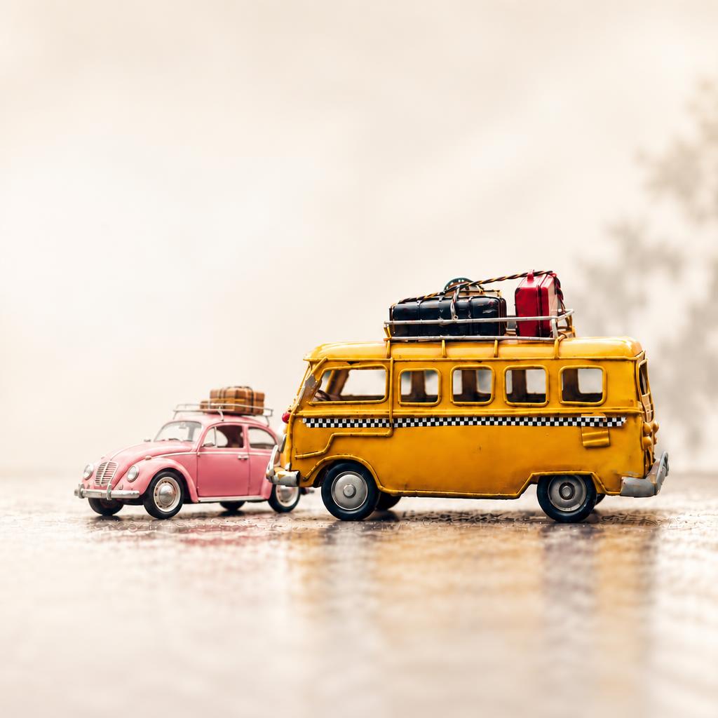 Yellow vintage travel van and pink Volkswagen Beetle on a sunlit road